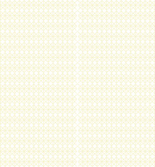 A white and yellow patterned rug is layered with pieces of colorful wrapping paper scattered on top.