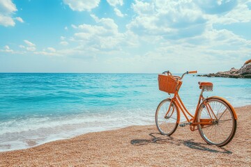 Fototapeta premium Orange bicycle on sandy beach, near turquoise sea. Perfect for travel, vacation, and summer themes.