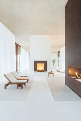 Fototapeta premium Modern minimalist living space with fireplace and outdoor views during daylight