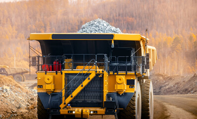 Massive Mining Dump Truck Transporting Ore in Open Pit Mine at Sunset © Parilov