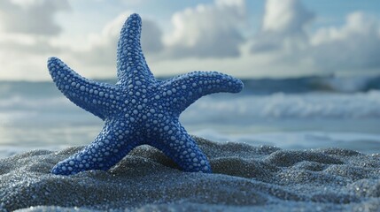 Blue starfish on sandy beach near ocean waves.