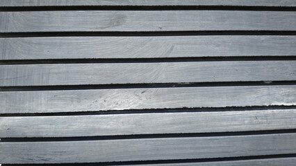 Fototapeta premium A close-up view of a weathered wooden wall, showcasing a rich texture of horizontal planks and visible grain patterns