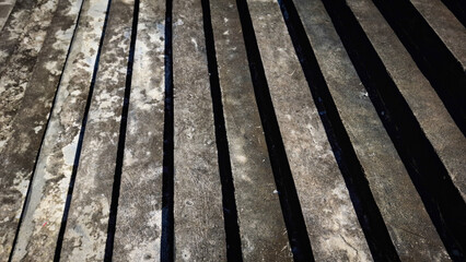 Fototapeta premium A close-up view of a weathered wooden boardwalk, showcasing a rich texture of horizontal planks and visible grain patterns
