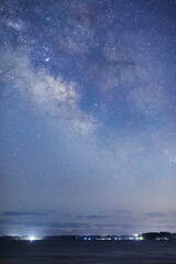 能登半島の海辺から望む天の川の縦画像