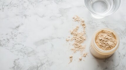 Protein powder with glass of water on marble surface for nutrition and fitness