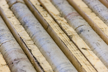 A row of wooden boards with a few of them having writing on them