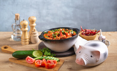 Baked meat in tomato sauce with herbs in a ceramic dish.