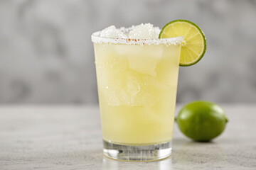 Fototapeta premium Frozen lime margarita with a salted rim, served in a chilled glass, perfect for a refreshing cocktail showcase