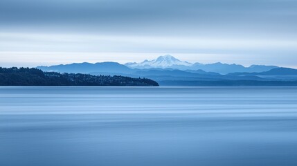 Fototapeta premium Serene mountain vista over calm water.