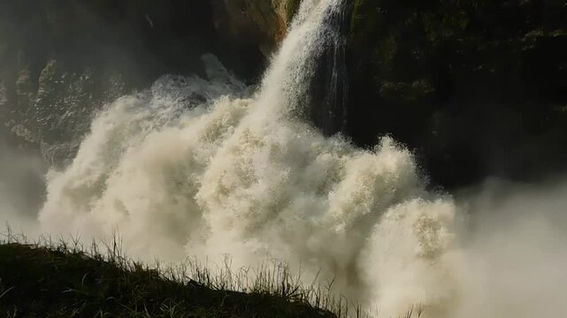 Static shot of the powerful, foamy stream of Murchison Falls on a sunny day in northern Uganda.