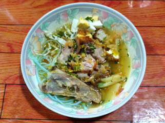 Soto Ayam in Indonesia. Soto ayam is a traditional Indonesian dish that uses ingredients such as shredded chicken, potatoes, eggs, rice vermicelli, bean sprouts with a delicious sauce.