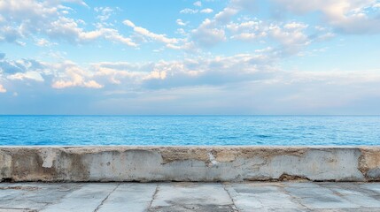 Seascape Panorama of Clear Blue Sky and Ocean with Coral Concrete Wall in Foreground Ideal for Travel and Coastal Themes
