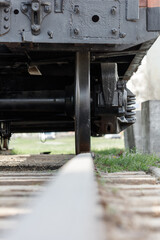 A train engine is shown with its wheels off the tracks