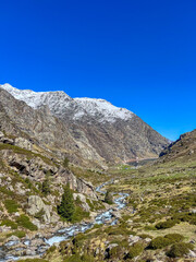 Snow dusted mountains crystal clear water lake Soulcem valley pyrenees