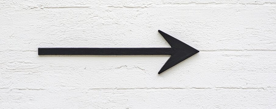 A simple black arrow pointing right against a textured white background, symbolizing direction and movement.