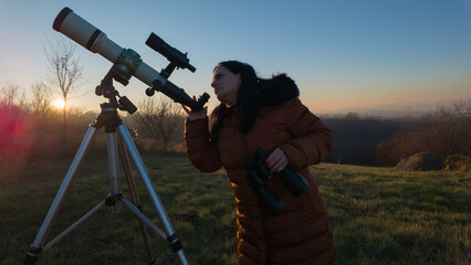 Amateur astronomer observing skies with telescope.