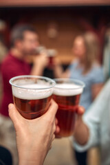Group of friends enjoying cold beer at a backyard party.
