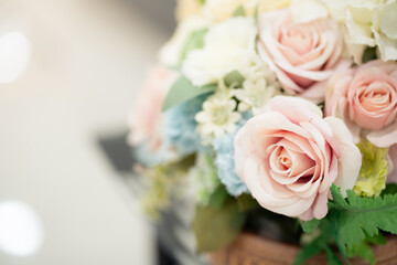 Close up and selective focus beautiful plastic soft pink  roses in vase ,flowers in room or wedding.
