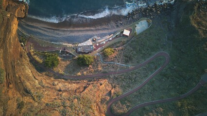 Aerial View of Coastal Road and Ocean Shoreline at Sunrise
