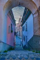 A street among the old houses of a historic district of the city of Gaeta, Italy.