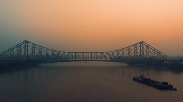 Aerial view of Kolkata Iconic Howrah Bridge or Rabindra Setu over Ganga River during Sunset