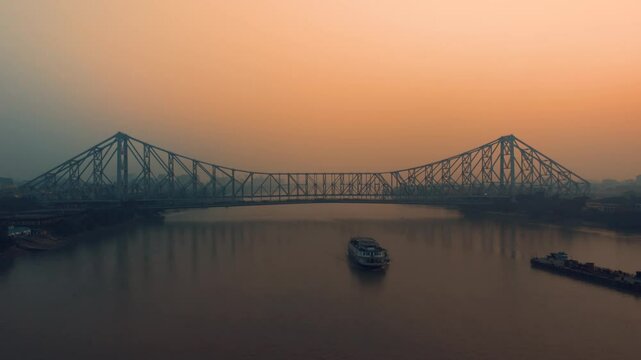Aerial view of Kolkata Iconic Howrah Bridge or Rabindra Setu over Ganga River during Sunset