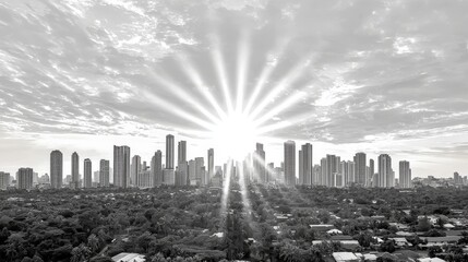Stunning Black and White Sunrise Over Urban Skyline with Bright Rays Spreading Out