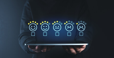 Customer satisfaction feedback concept with digital rating icons over tablet.