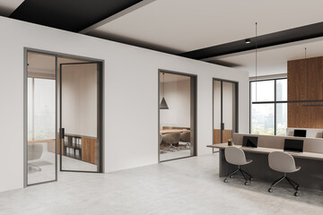 Modern open-space office interior with glass-partitioned rooms, wooden accents, large windows, minimalist furniture, and concrete flooring. 3D Rendering