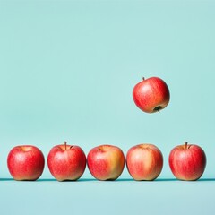Five red apples in a row, one falling.