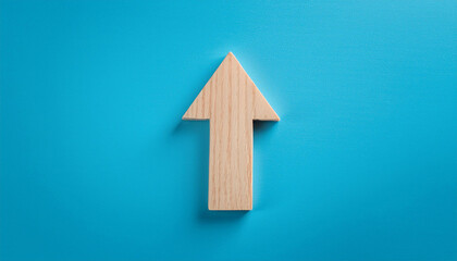 Minimalist wooden arrow on blue background. Wood pointer, forward direction, up.