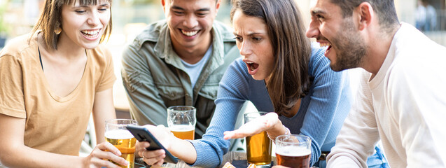 Banner with Group of friends reacting with surprise and amusement while looking at a smartphone. Young adults sharing a shocking or funny moment over drinks at an outdoor cafe