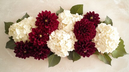 Burgundy dahlias and white hydrangeas on taupe background with light