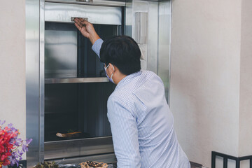 Chef use Dumbwaiter Lift elevator in a kitchen of Restaurant or Hotel used for carrying food ready Serve to customer. Waiters carry food from the Dumbwaiter Lift elevator and prepare to serve