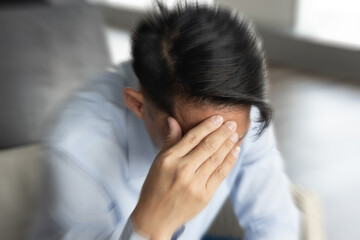 Stressful and mentally exhausted Asian Man feeling exhausted with migraine headache