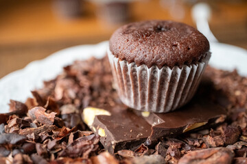 chocolate muffin and cacao beans on a plate