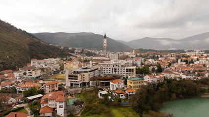 Aerial view of people crossing Old Bridge over Neretva river in Mostar, Bosnia and Herzegovina.
