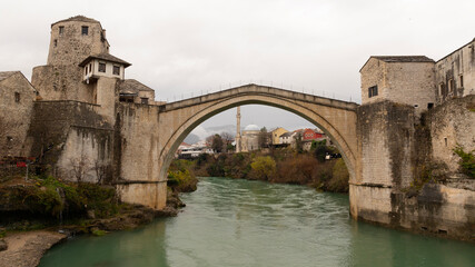Aerial view of people crossing Old Bridge over Neretva river in Mostar, Bosnia and Herzegovina.