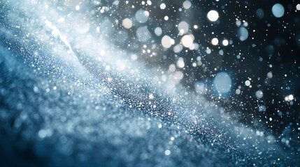 A vibrant winter abstract featuring dynamic streaks of ice blue, silver, and white, reminiscent of a snowstorm.