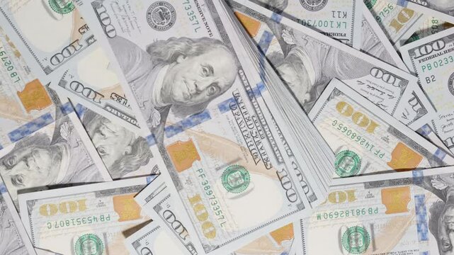 Throwing and taking back a large wad of hundred-dollar bills in an active motion, displayed over a spread of scattered currency in a financial-themed composition.