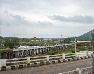 India, Karnataka, a train traveling down train tracks near a field