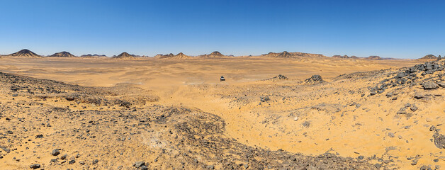 Black Desert, Egypt - part of the widest hot desert in the World, the Sahara, the Black Desert displays a very peculiar shape and color, due to the basalt topping the sand mounds 
