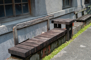 a wooden bench set against a concrete wall, blending rustic charm with simplicity