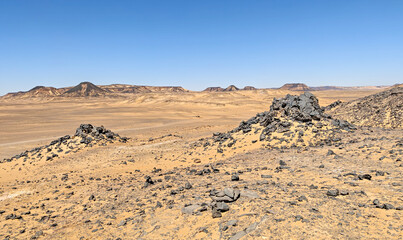 Black Desert, Egypt - part of the widest hot desert in the World, the Sahara, the Black Desert displays a very peculiar shape and color, due to the basalt topping the sand mounds 
