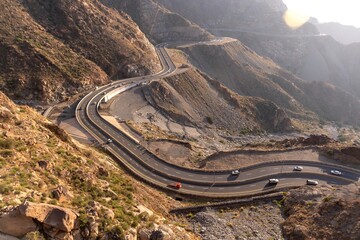 Aerial view of a highway and cars between rocky mountains in Taif city, Saudi Arabia