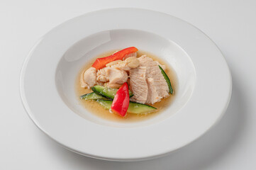 Steamed chicken with vegetables and almonds , traditional Chinese dish isolated on white background