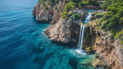 Fototapeta premium a waterfall by the cliff seen from aerial view