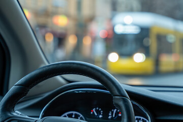 A car is driving down a street with a yellow bus in the background. The driver is looking at the...