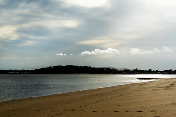 Late afternoon view from Coochiemudlo Island toward Victoria Point with sunlight reflecting off the water