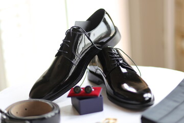 Still Life of Men's Formal Wear: Dress Shoes, Belt and Cufflinks for a Wedding